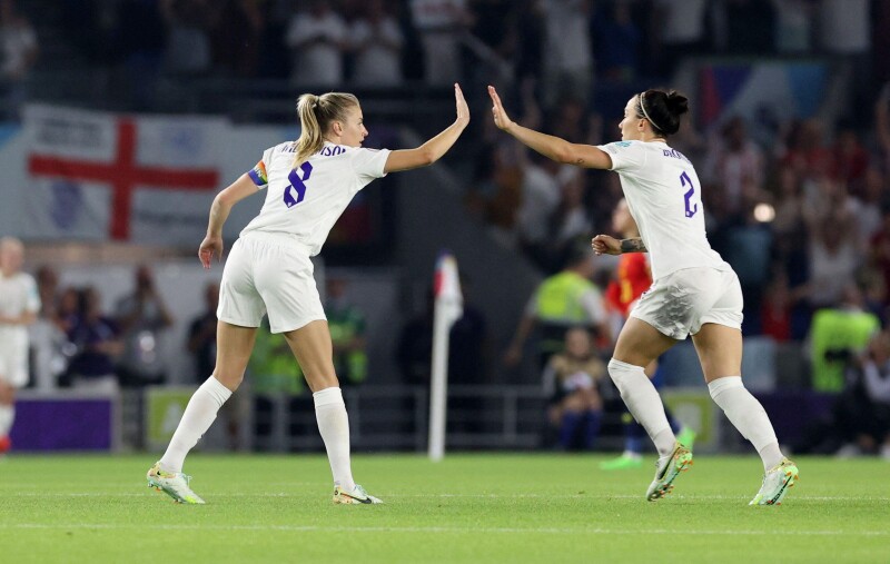 Soccer Football - Women's Euro 2022 - Quarter Final - England v Spain - The American Express Community Stadium, Brighton, Britain - July 20, 2022 England's Leah Williamson and Lucy Bronze celebrate their first goal scored by England's Ella Toone REUTERS/B