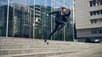 Happy brunette male jumping down in hurry