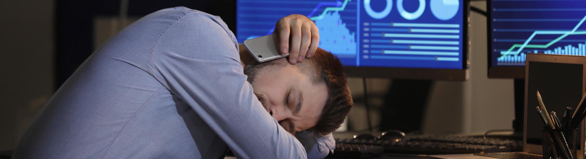 Tired stock exchange trader sleeping in office