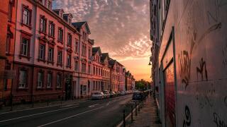 sunset on the street in Germany with warm color clouds and nearly empty street
