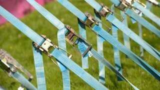Row of tension tightening straps and pulleys on a large marquee