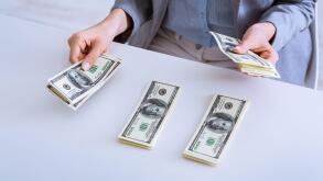 Distribution of funds. Female hands lay money