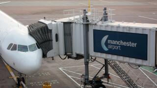 Civil aviation. Commercial air transport. Passenger jet plane connected to its jetbridge on the ramp or apron at Manchester Airport, UK