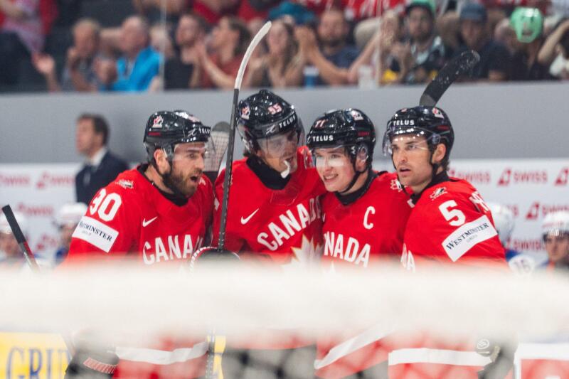 FRIBOURG, FRIBOURG - MAY 28: Canada players celebrate for the first time after Macklin Celebrini scored during the 2026 IIHF World Championship quarterfinal match between Canada and the United States at BCF Arena on May 28, 2026 in Fribourg, Fribourg, Swi