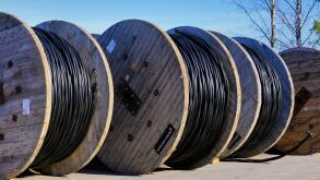 Prysmian Group Wiski Plain cable reels for ground installations at rural work site with blue sky background. Marttila, Finland. April 6, 2019.