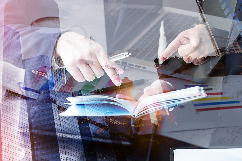 Financial Manager In talks with employees in the company,Goal of the Firm,Double exposure business,laptop Put on a wooden table made with vintage tones,The media reaches the operational guidelines