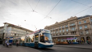 A tramway train is leaving the tram station at Zurich's Paradeplatz with headquarters of the Swiss banks UBS and Credit Suisse
