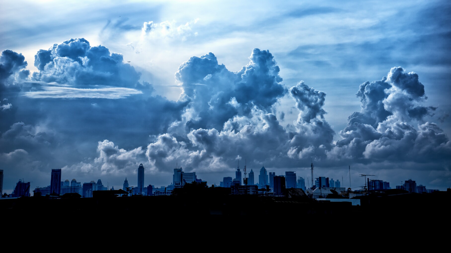 Dark blue storm clouds over city in rainy season