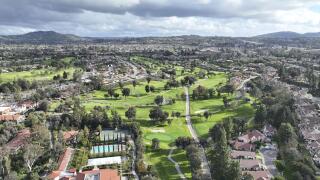 Aerial view of residential neighborhood surrounded by golf and valley during cloudy day in Rancho Bernardo, San Diego County, California. USA
