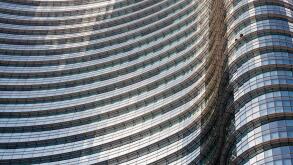 UniCredit Tower in the Porta Nuova District, Milan, Lombardy, Italy. Exterior view of curved glass facade of the tallest building in Italy.