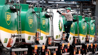 BP tankers lined up for inspecton with BP employee checking them over.. Image shot 2002. Exact date unknown.