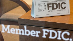 Bank Member FDIC Sign on Window and Desk, USA. Image shot 2013. Exact date unknown.