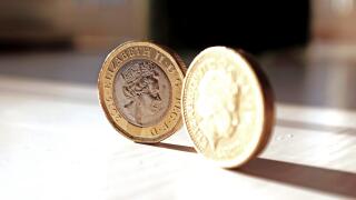 The new pound coin (left) and old pound coin British money sterling