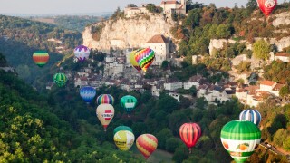 Hot air balloons rise just after dawn at Rocamadour, Midi-Pyrenees, France