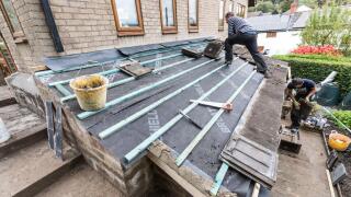 Building roofing house extension, Wales, UK