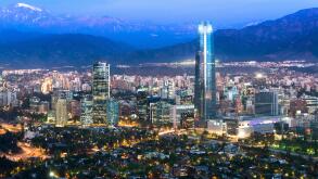 Panoramic view at night of Santiago de Chile with The Andes Mountain Range in the back