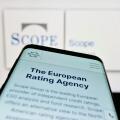 Stuttgart, Germany, 03-13-2023: Smartphone with website of European fund rating company Scope Group on screen in front of business logo. Focus on