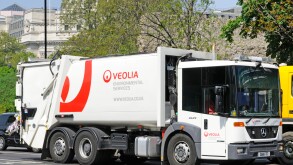 Veolia environmental services hgv tipper truck dustcart rubbish collection commercial vehicle driving along London street in Tower Hamlets England UK