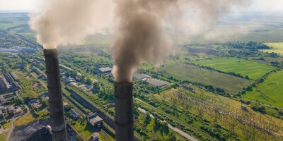 Aerial view of coal power plant high pipes with black smokestack