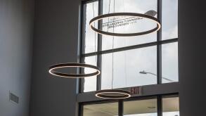Large circular lights hanging from the ceiling inside a doctor's office entrance.
