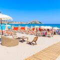 CALVI, CORSICA ISLAND - JUN 28, 2015: A view of Calvi beach with umbrellas and sunbeds on hot summer day, Corsica island, France
