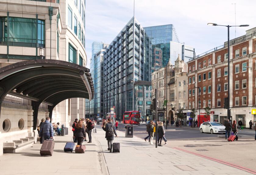 People in Bishopsgate, City of London street scene, looking towards the RBS building, Spitalfields East London UK