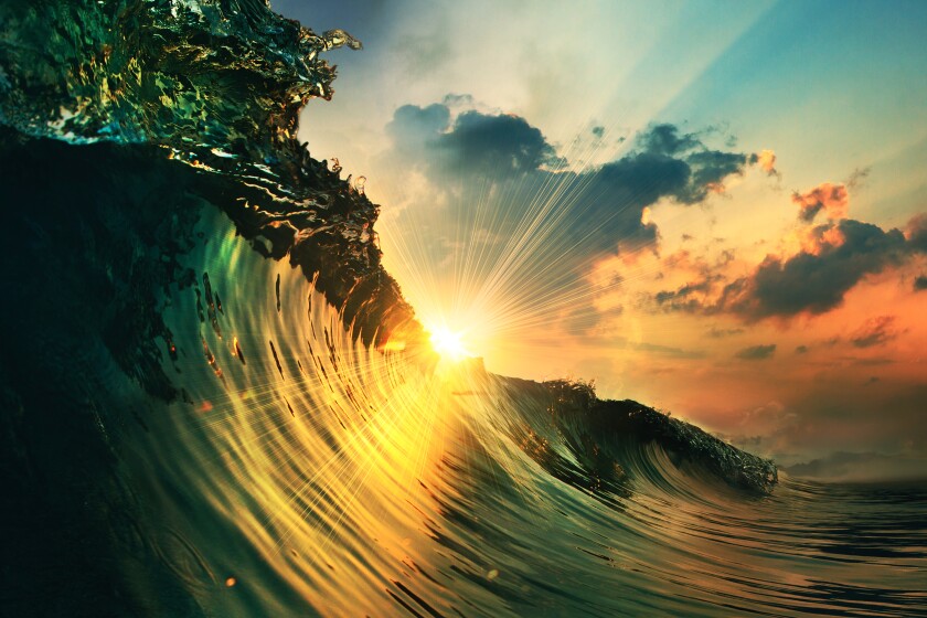 ocean wave falling down at sunset time-adobe