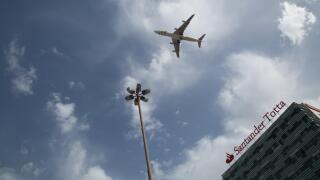 An aeroplane flying low over a hotel in Lisbon. Portugal.