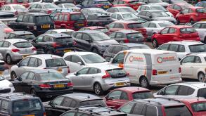 Elevated view of vehicles (Cars and a van) parked in a car park at Ardrossan Harbour, North Ayrshire, Scotland, UK