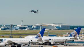 An aeroplane of the airline Lufthansa is taking off at Frankfurt International Airport, two more aeroplanes are parking on the g