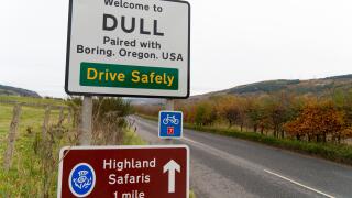 Road sign at Scottish village called Dull near Aberfeldy in Perthshire, Scotland , UK