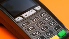 Close-up of a credit card machine. Contactless and cashless acceptance of payments by bank card or phone. Terminal for paying for purchases. Customer