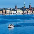Early morning view of Stockholm waterfront building on Stadsholmen island with Stockholm ferry in foreground, Stockholm, Sweden, Northern Europe