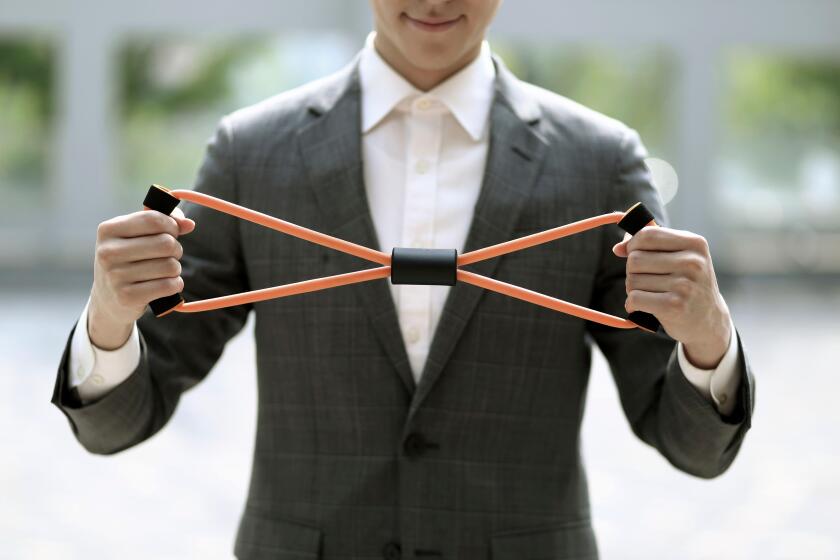 Businessman exercising with resistance band
