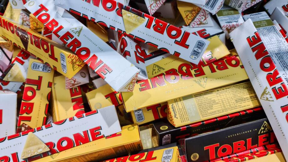 Kiel, Germany - 18. June 2025: Many Toblerone chocolate bars stacked together, creating a mountain of sweet treats