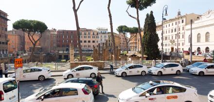 Taxi cars parked in street in Rome, Italy