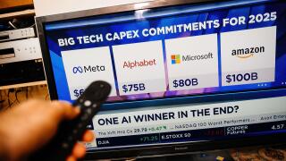 Paris, France - Feb 19, 2025: A person holds a remote while watching CNBC on a Panasonic TV, displaying Meta, Alphabet, Microsoft, and Amazon 2025 cap