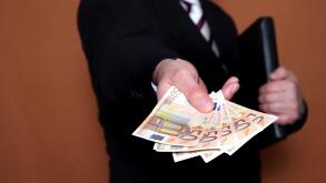 businessman offering Euro banknotes