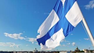 Flag of Finland against Helsinki panorama