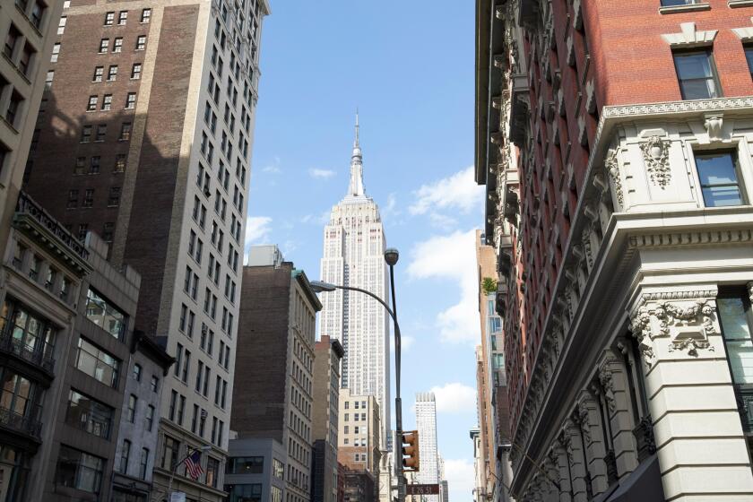 the burton building looking up 5th avenue with view of the empire state building New York City USA