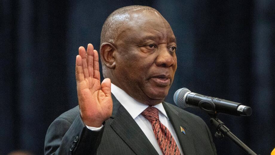 South African President Cyril Ramaphosa raises his hand as he is sworn is as a member of Parliament ahead of an expected vote by lawmakers to decide if he is reelected as leader of the country in Cape Town, South Africa, Friday, June 14, 2024. (AP Photo/J
