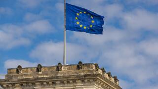 The EU European Union flag flies on top of the Reichstag German Parliament (Bundestag) building, Berlin, Germany