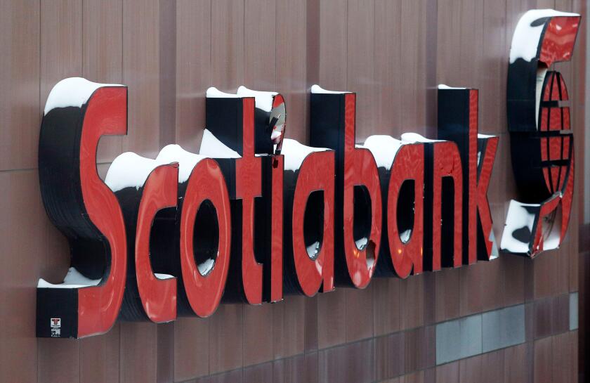 Snow covers the Scotiabank logo at the Bank of Nova Scotia headquarters in Toronto December 16, 2013. REUTERS/Chris Helgren (CANADA - Tags: BUSINESS LOGO ENVIRONMENT)