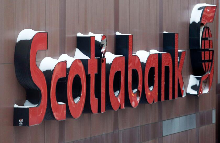 Snow covers the Scotiabank logo at the Bank of Nova Scotia headquarters in Toronto December 16, 2013.  REUTERS/Chris Helgren  (CANADA - Tags: BUSINESS LOGO ENVIRONMENT)