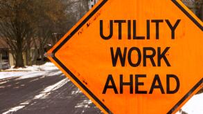 Utility work ahead road construction warning sign.