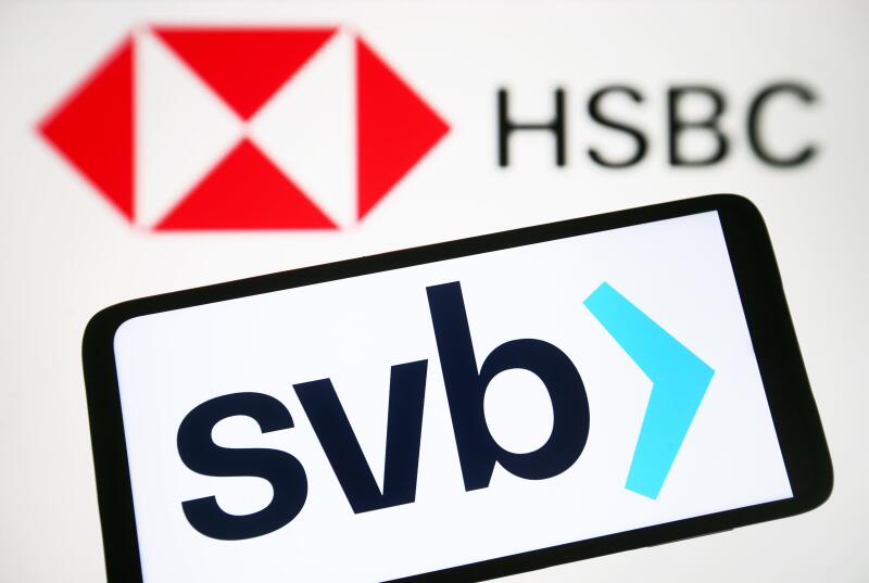 In this photo illustration, Silicon Valley Bank (SVB) logo is seen on a smartphone and HSBC UK Bank plc logo on a pc screen.