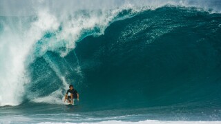 Surfer riding huge wave, Bonzai Pipeline, North Shore, Oahu, Hawaii