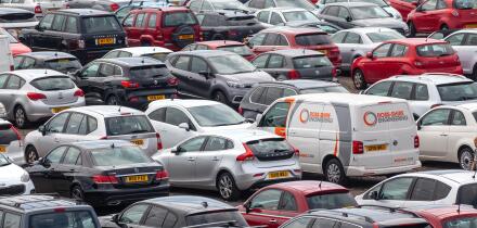 Elevated view of vehicles (Cars and a van) parked in a car park at Ardrossan Harbour, North Ayrshire, Scotland, UK