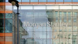 Facade of the modern bank of Morgan Stanley with reflections and a nostalgic lantern in London,
