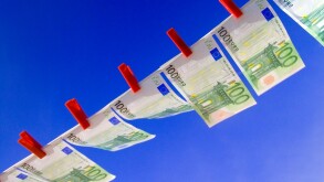 EURO NOTES WASHING LINE Crisp new 100 Euro notes fluttering flying high in the breeze pegged in a line against a sunny blue sky Horizontal Landscape